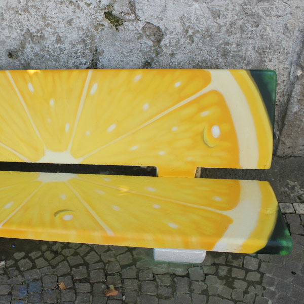 Street art su Panchina dipinta a limone, realizzata a spray da Pao. 