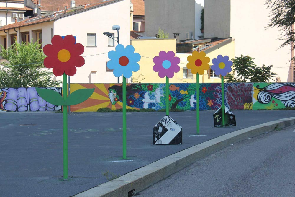 Street art Flowers on old road signs in Milan. 