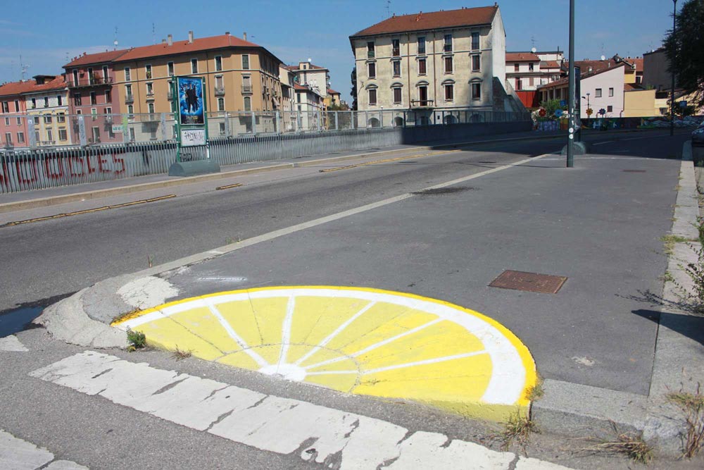 Lemon painted on sidewalk in Milan. Street art by Pao